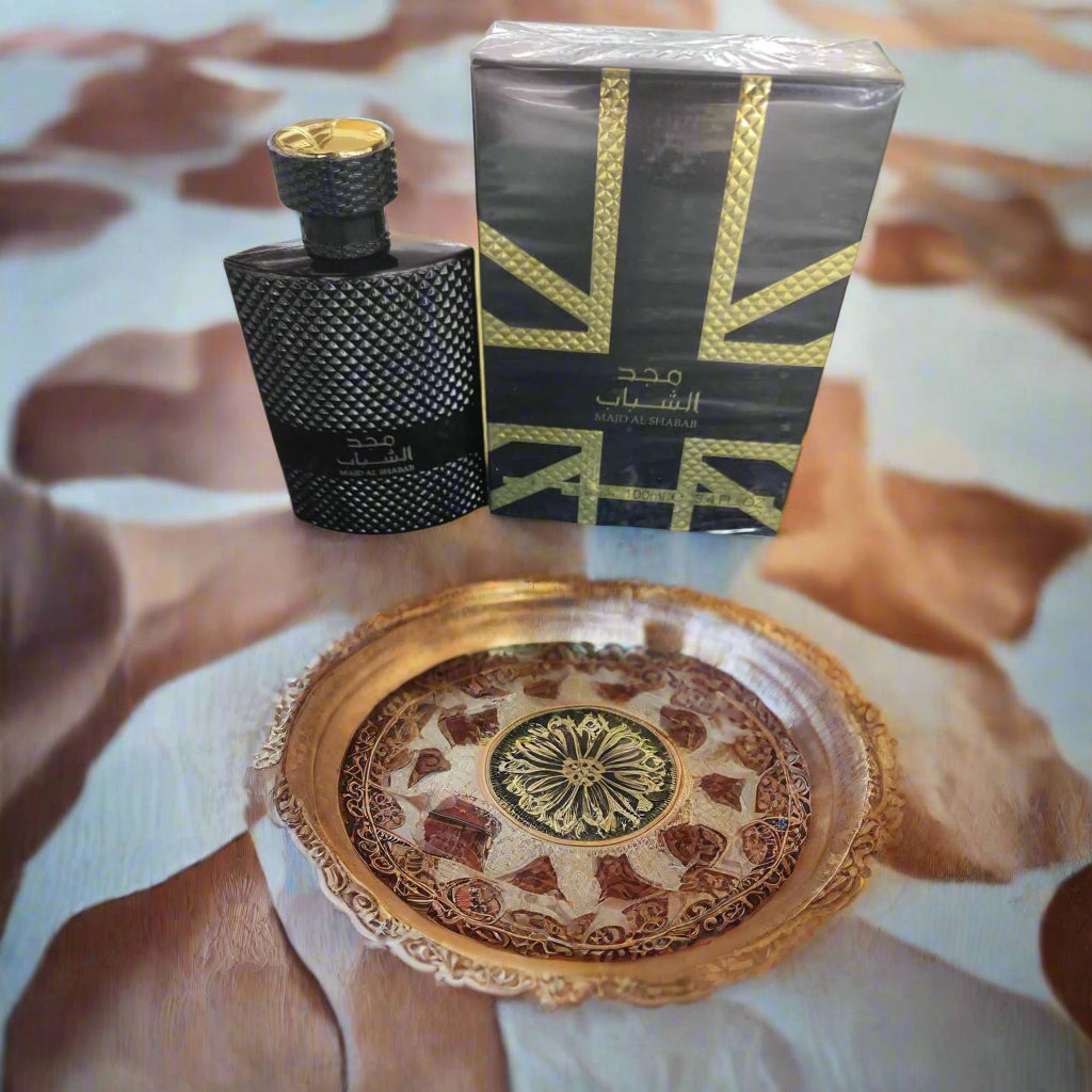 Black textured perfume bottle with Union Jack design packaging on a beige background