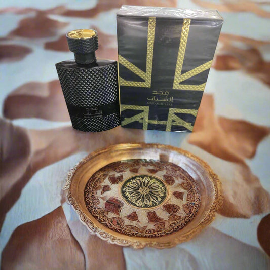 Black textured perfume bottle with Union Jack design packaging on a beige background